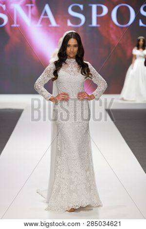 ZAGREB, CROATIA - FEBRUARY 02, 2019: Fashion model in a wedding dress walking down the runway at the Wedding fair