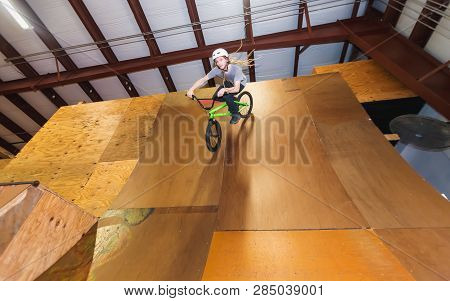 Man Jumping And Riding On A Bmx Bicycle At An Extreme Sports Park