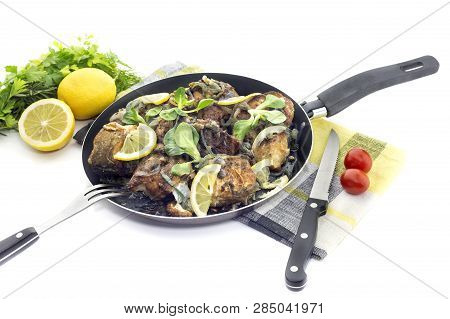 Fish Dishes. Fresh, Hot, Fried Cod Fish With Onions In A Frying Pan Close-up On White Background