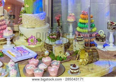 Wedding Cake And Specific Sweets Decorated With Artificial Flowers And Painted.
