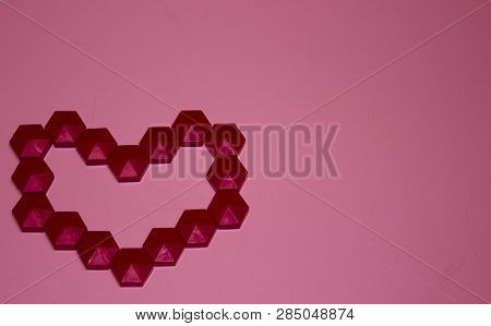 Red Heart Made Of Mosaic On The Left On A Coral Background Top View