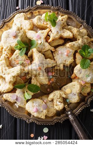 Christmas Figure Cookies With Pecans, Anise And Mint Decorated With Candy Sprinkles Close-up On A Di