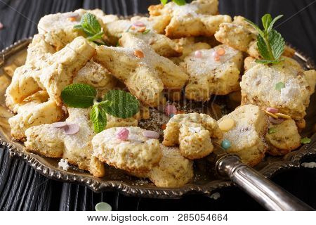 Mexican Hojarascas Curly Festive Cookies With Pecans Closeup On A Dish. Horizontal