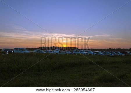 Beautiful Sunset At Summer  Soltice Over Parked Cars In The Open Air