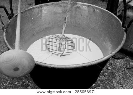 Big Pot Where A Cheesemaker Are Making Cheese From The Milk