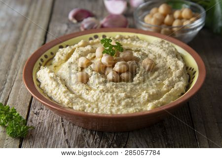 Delicious Homemade Hummus Pasta With Olive Oil And Cheakpeas. Wooden Table.
