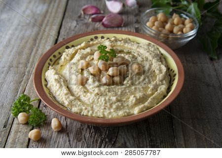Delicious Homemade Hummus Pasta With Olive Oil And Cheakpeas. Wooden Table.