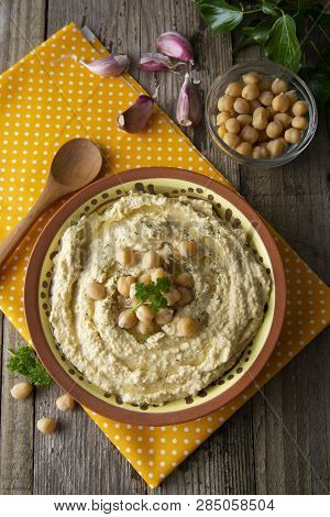Delicious Homemade Hummus Pasta With Olive Oil And Cheakpeas. Wooden Table.