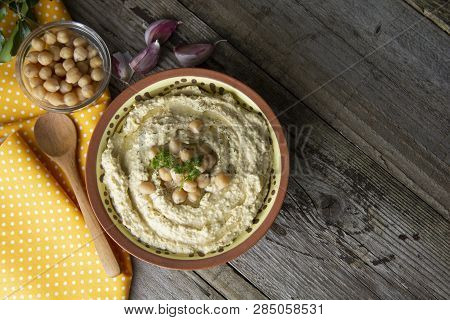 Delicious Homemade Hummus Pasta With Olive Oil And Cheakpeas. Wooden Table.