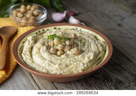 Delicious Homemade Hummus Pasta With Olive Oil And Cheakpeas. Wooden Table.