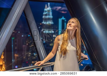 Woman Looks At Kuala Lumpur Cityscape. Panoramic View Of Kuala Lumpur City Skyline Evening At Sunset