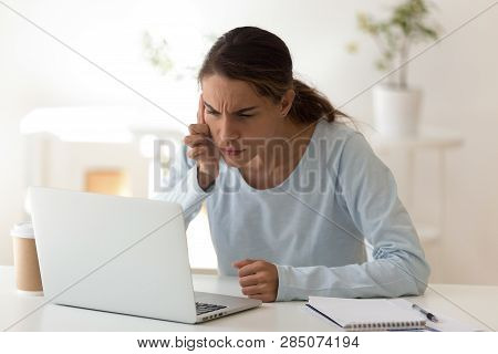 Young Woman With Poor Vision Looking At Computers Screen