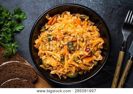 Cabbage Stew With Rice And Vegetables. Meatless Vegan Dish. Top View On Black Stone Table.