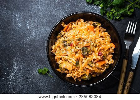 Cabbage Stew With Rice And Vegetables. Meatless Vegan Dish. Top View On Black Stone Table.