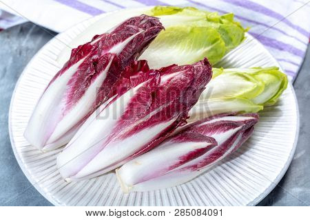 Group Of Fresh Green Belgian Endive Or Chicory And Red Radicchio Vegetables, Also Known As Witlof Sa