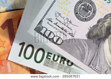 One Hundred Dollas And One Hundred Euro Bills Close-up. Top View.