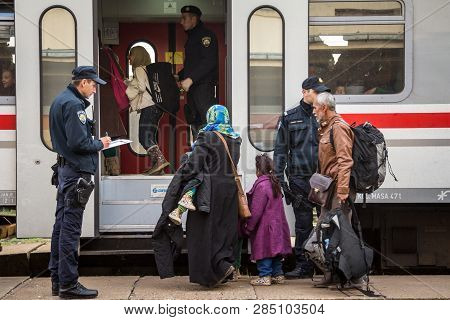 Sid, Serbia - November 14, 2015: Croatian Police Officers Checking Refugees, Boarding A Train To Cro