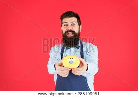 Baked With Love. Hipster Bearded Baker Hold Glazed Donut On Red Background. Cafe And Bakery Concept.