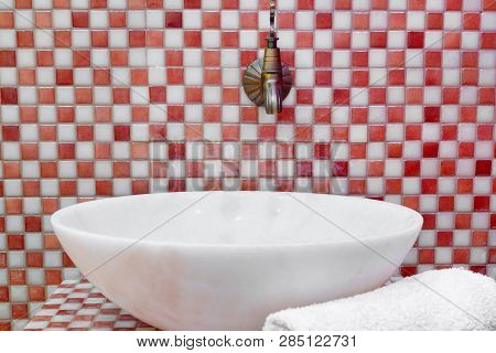 Traditional Turkish Hamam With Stone Walls, Sink And Stack Of  Towels