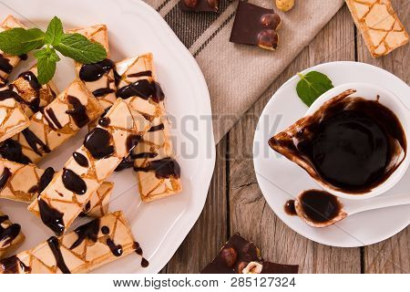 Puff Pastry Cookies With Chocolate Icing On White Dish.