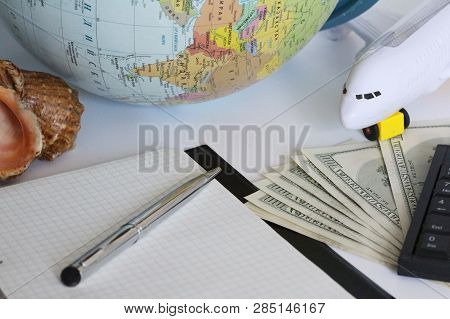 Planning A Trip Around The World. On Holiday With The Whole Family. In The Photo: Plane, Money, Shel