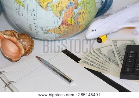 Planning A Trip Around The World. On Holiday With The Whole Family. In The Photo: Plane, Money, Shel