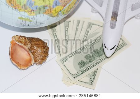 Planning A Trip Around The World. On Holiday With The Whole Family. In The Photo: Plane, Money, Shel