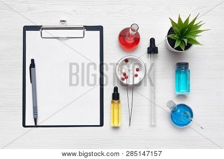 Laboratory Table With A Blank Paper Sheet Of Researching Results Or Medical Recipe And A Chemical Re