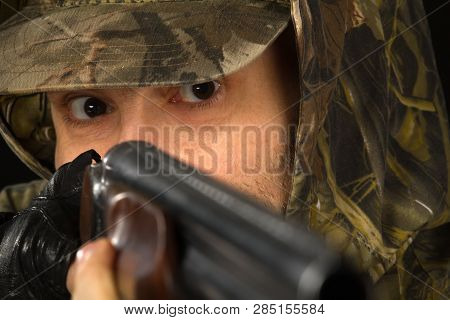 Eyes Of A Hunter Aiming With A Shotgun, Closeup