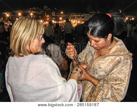 Jemma El- Fnn Markets, Marrakesh Morocco - Circa November 2010 - Tourist Gets A Tattoo In Jemma El-f