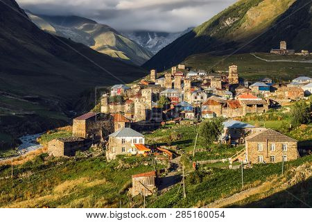 Ushguli Village With A Shkhara Mountain Hiding In The Clouds On The Background. Chvibiani And Zhibia