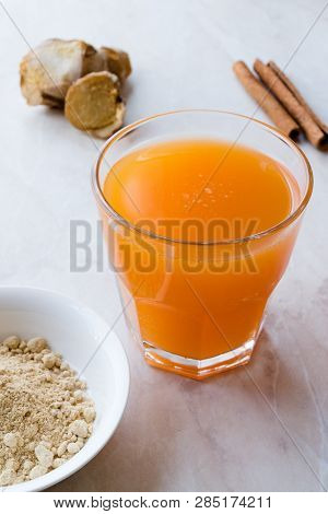 Jamu Healthy Asian Drink With Turmeric And Cinnamon Stick, Orange Juice
