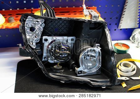 Macro View Of Repairing, Installation And Turning Headlight Of Modern Automobile And Car Projector L