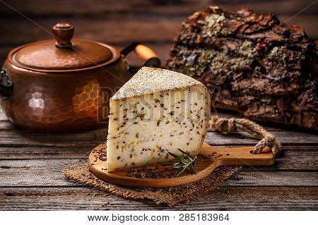 Piece Of Cheese With Cummin On Vintage Wooden Background