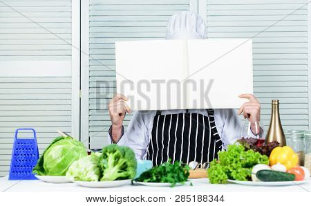 Book Recipes Copy Space. Man Chef In Hat And Apron Read Book. Culinary Recipes Book Concept. Improve