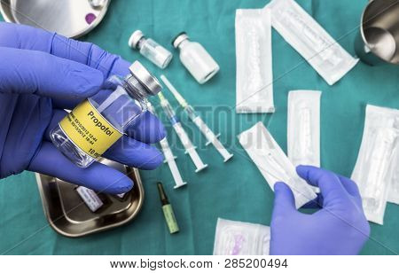 Nurse Preparing Hospital Medication, Left Hand Holding Propofol Vial, Conceptual Image, Horizontal C