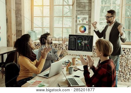 Group Of Designers Feeling Joyful In The Office