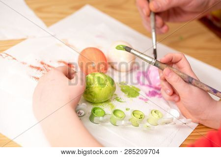 Close Up Of Kid  S Hand Holding An Ester Egg During Painting. Happy Ester Concept