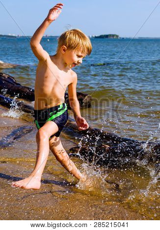 Happy Child Running On The Summer Beach