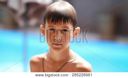 Portrait Wet Serious Boy After A Swimming Pool Looks At The Camera, Close-up