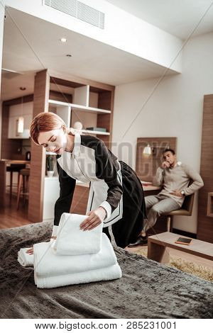 Blonde-haired Housekeeper Wearing White And Black Uniform Working