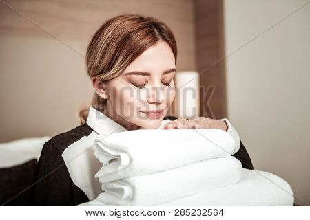 Housekeeper With Nice Natural Makeup Smelling Towels