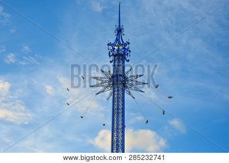 Orlando, Florida. January 19, 2019  People Enjoying Star Flyer Attraction On Cloudy Lightblue Backgr
