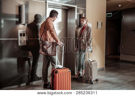 Businesswoman Wearing Oversized Jacket Waiting For Elevator