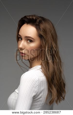 Portrait Of Beautiful Young Model In White T-shit Sitting On Brown Vintage Chair