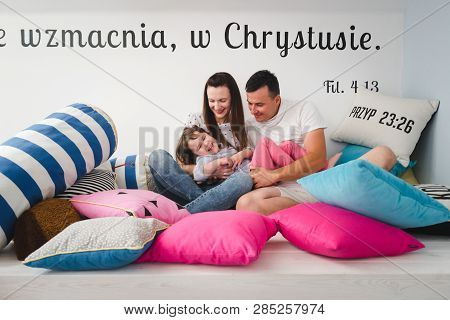 Smiling Happy Family And Young Funny Daughter. Family Concept.  On Background Bible Verses Philippia