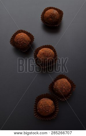 Chocolate Pralines Over Black Background. Top View.