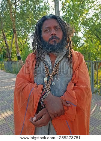 Tiruvanamalai, India - January 5, 2019:  Indian sadhu in the streets from Tiruvanamalai in India