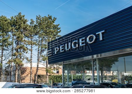 Roncq,france-february 20,2019:peugeot Logo On The Car Dealership Building.peugeot Is A French Compan