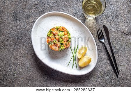 Peruvian Food. Salmon Ceviche With Avocado, Spring Onion And Lemon On White Plate Served With White 